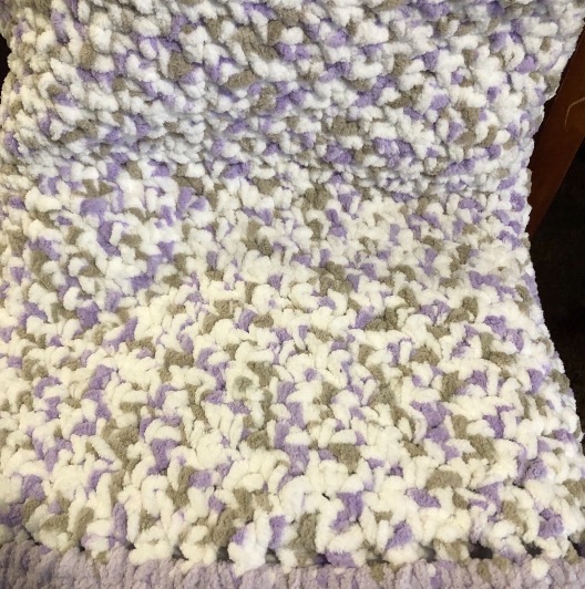 8. Lavender and while baby blanket
